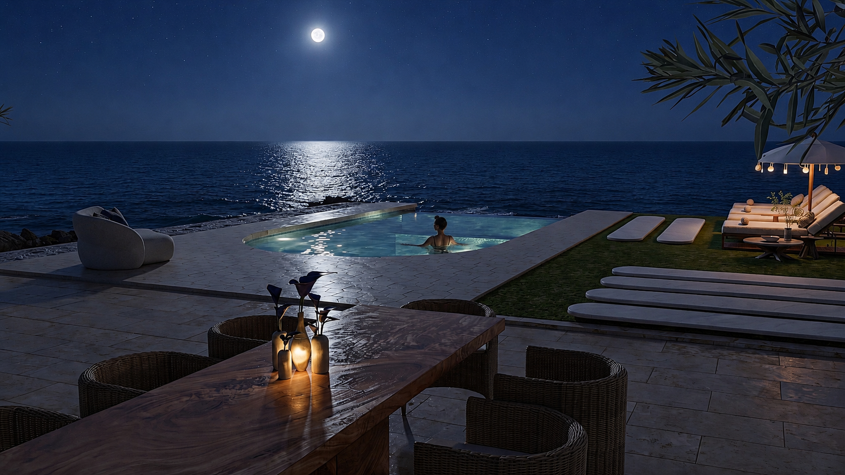 Moonlit poolside dining terrace overlooking the ocean